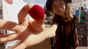 kid performing magic at the Sarah Hardy Farmers Market